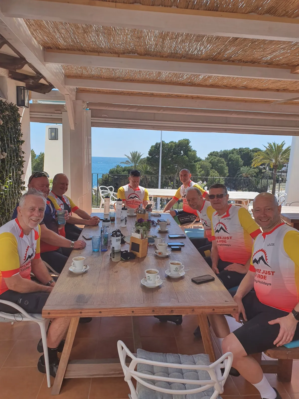 Never Just a Ride cycling group relaxing at a Costa Blanca coffee stop