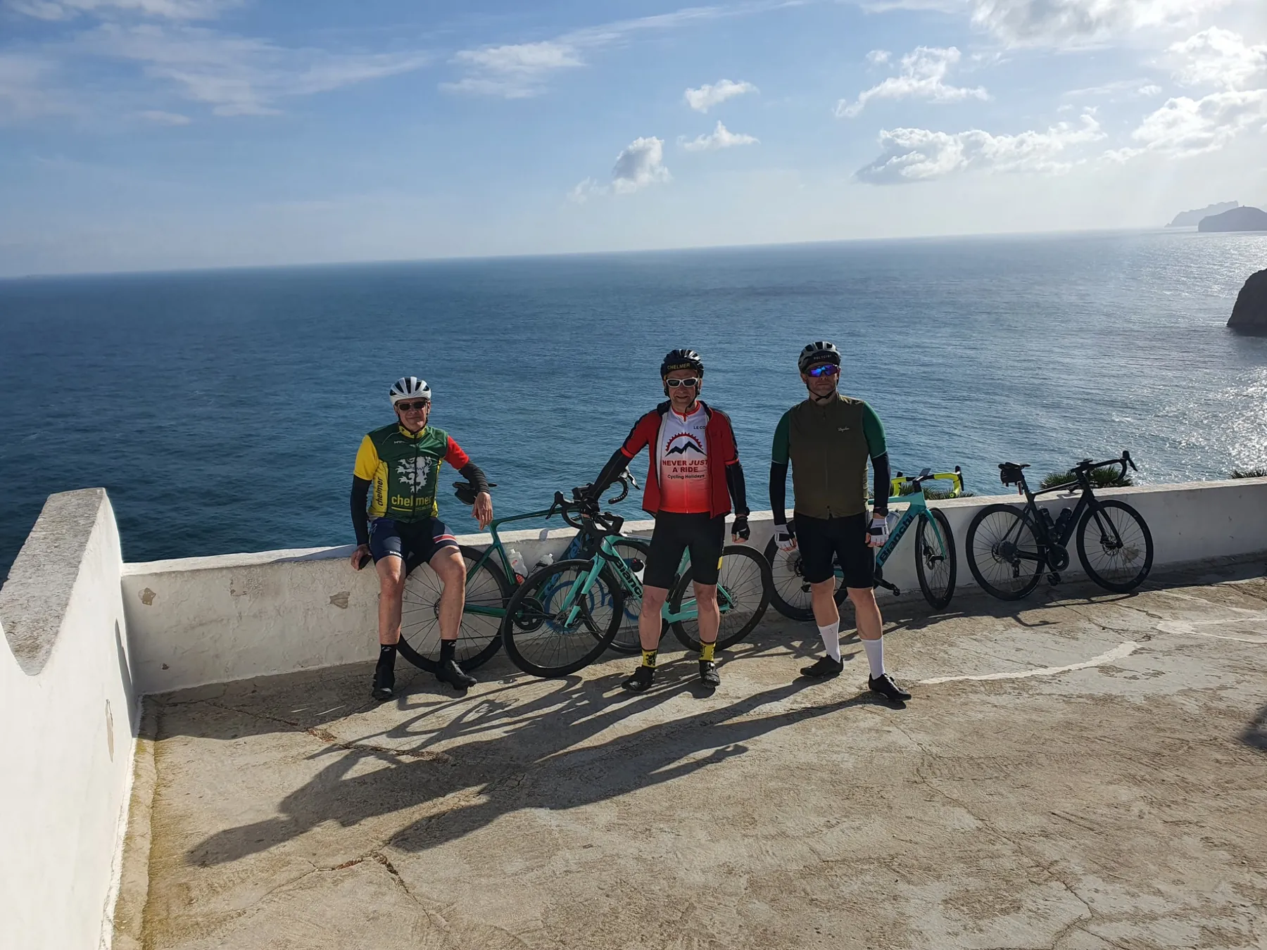 Road cyclists with their bikes overlooking the Mediterranean on the Costa Blanca